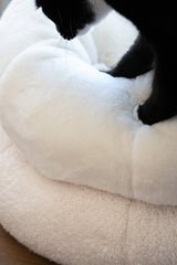 Tuxedo cat kneading Ocatnip's Sourdough Pudding Bed