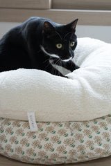 Tuxedo cat kneading Ocatnip's Marshmallow Pudding bed 